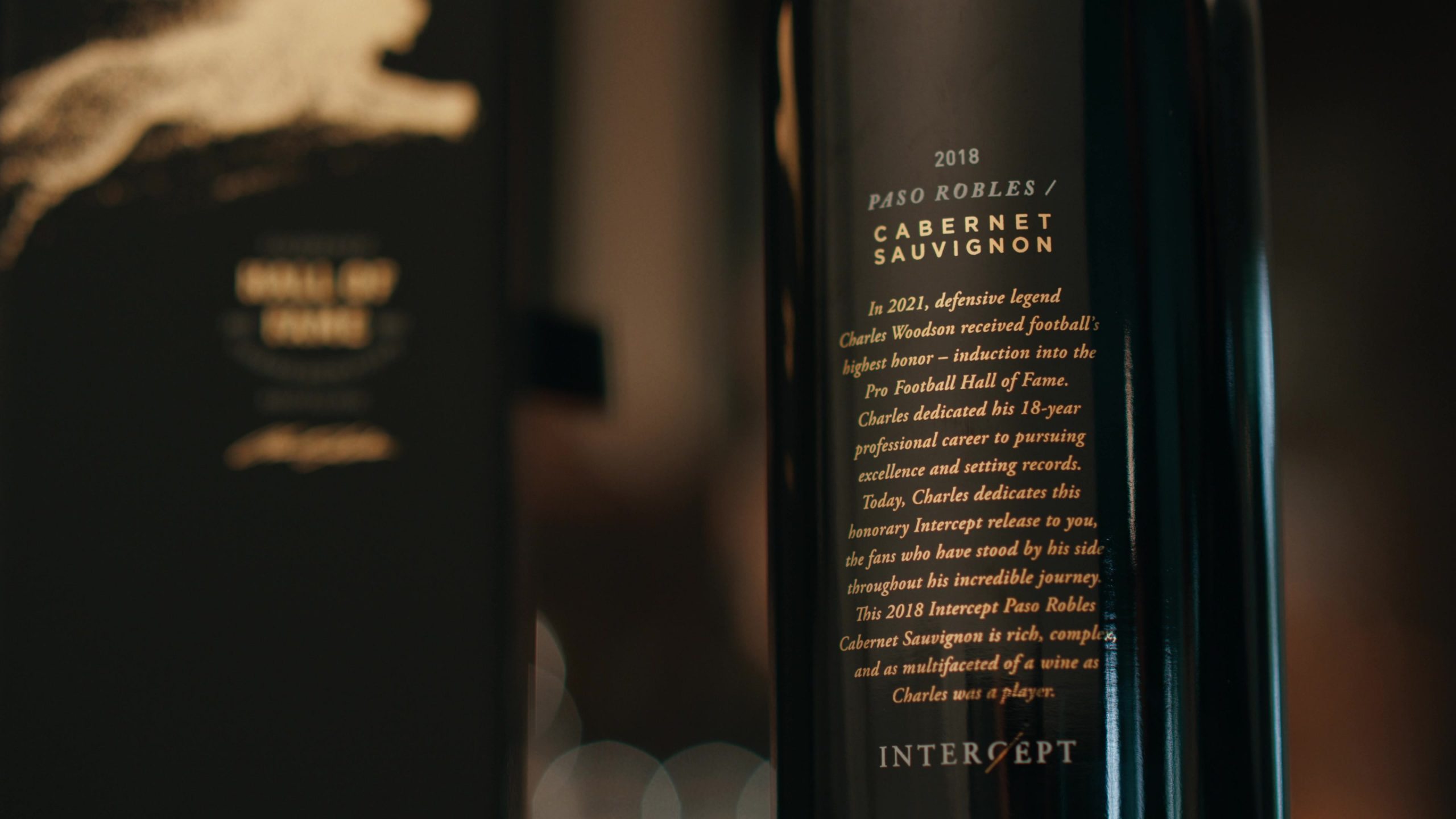 Close-up view of a 2018 Paso Robles Cabernet Sauvignon wine bottle with an honorary label dedicated to Charles Woodson's induction into the Pro Football Hall of Fame.