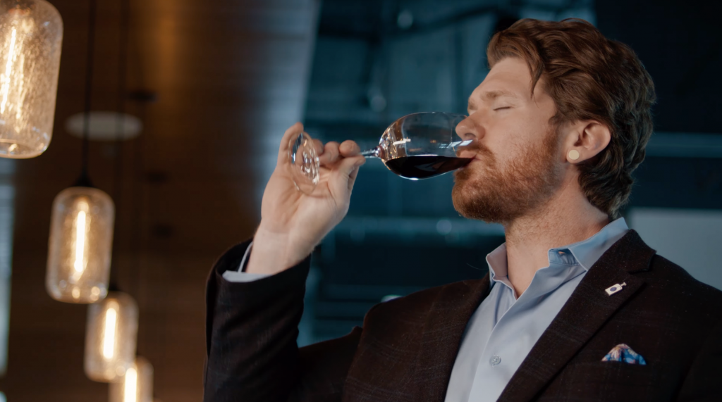 The Calling Wine Still 14 A person drinking red wine from a wine glass.